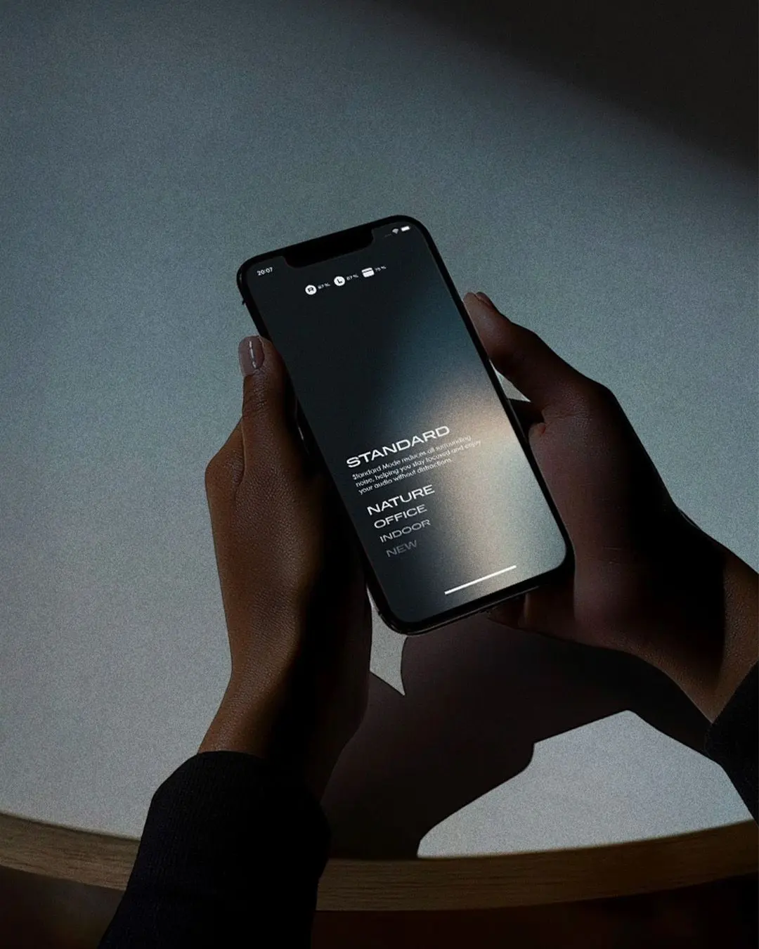 Hands holding a smartphone showing a web app